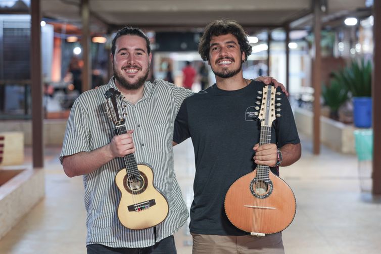 Brasília (DF), 17/01/2026 – Matheus Donato segurando seu cavaquinho de 6 cordas (e) e Ian Coury segurando bandolim de 10 cordas (d). Curso de verão na escola de música de Brasília. Foto: Joédson Alves/Agência Brasil